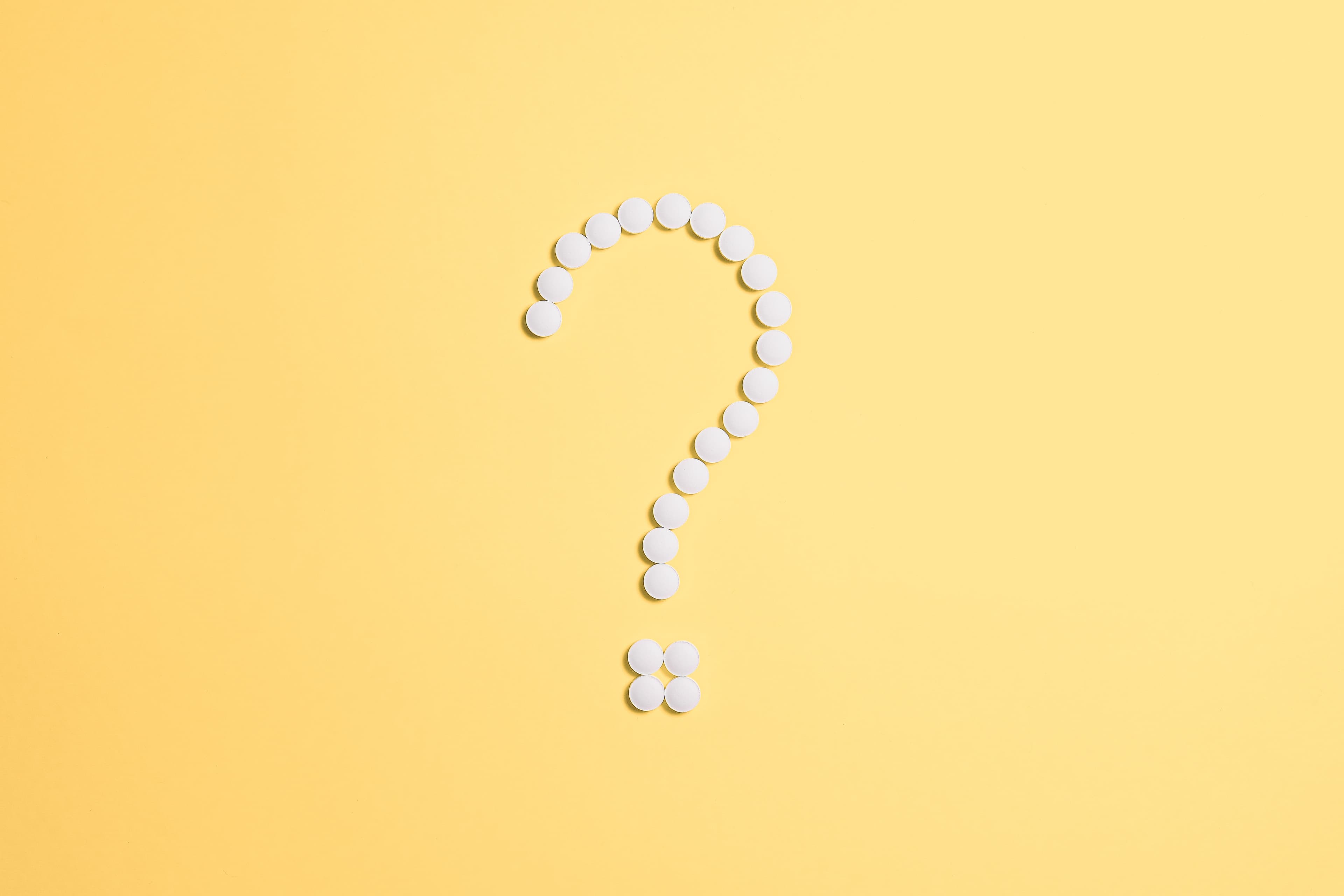 Question mark composed with dots on yellow background