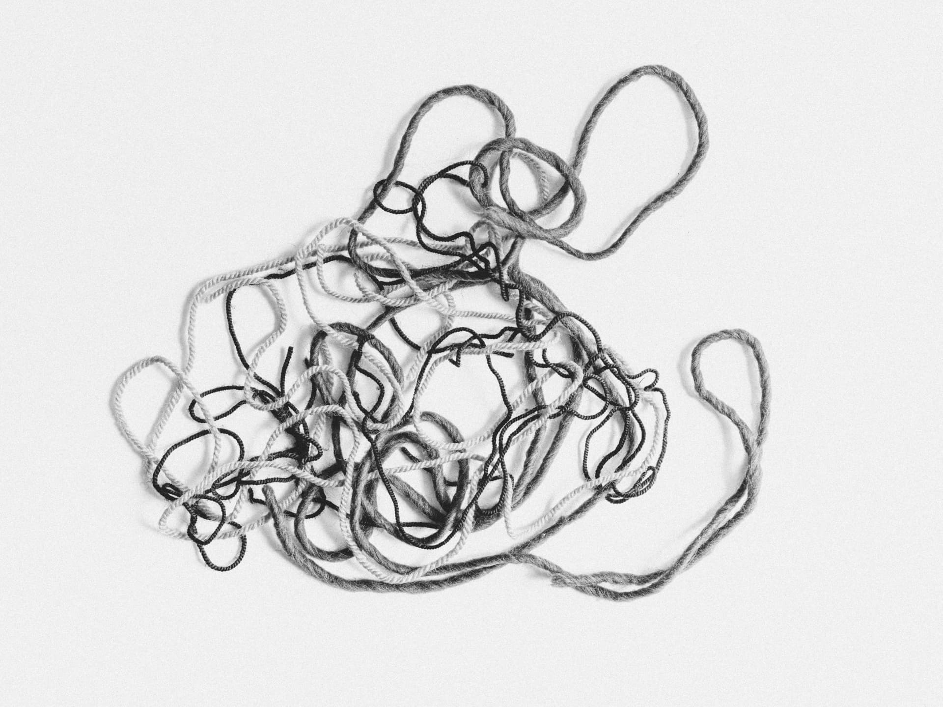 A tangled bundle of yarn on a white background