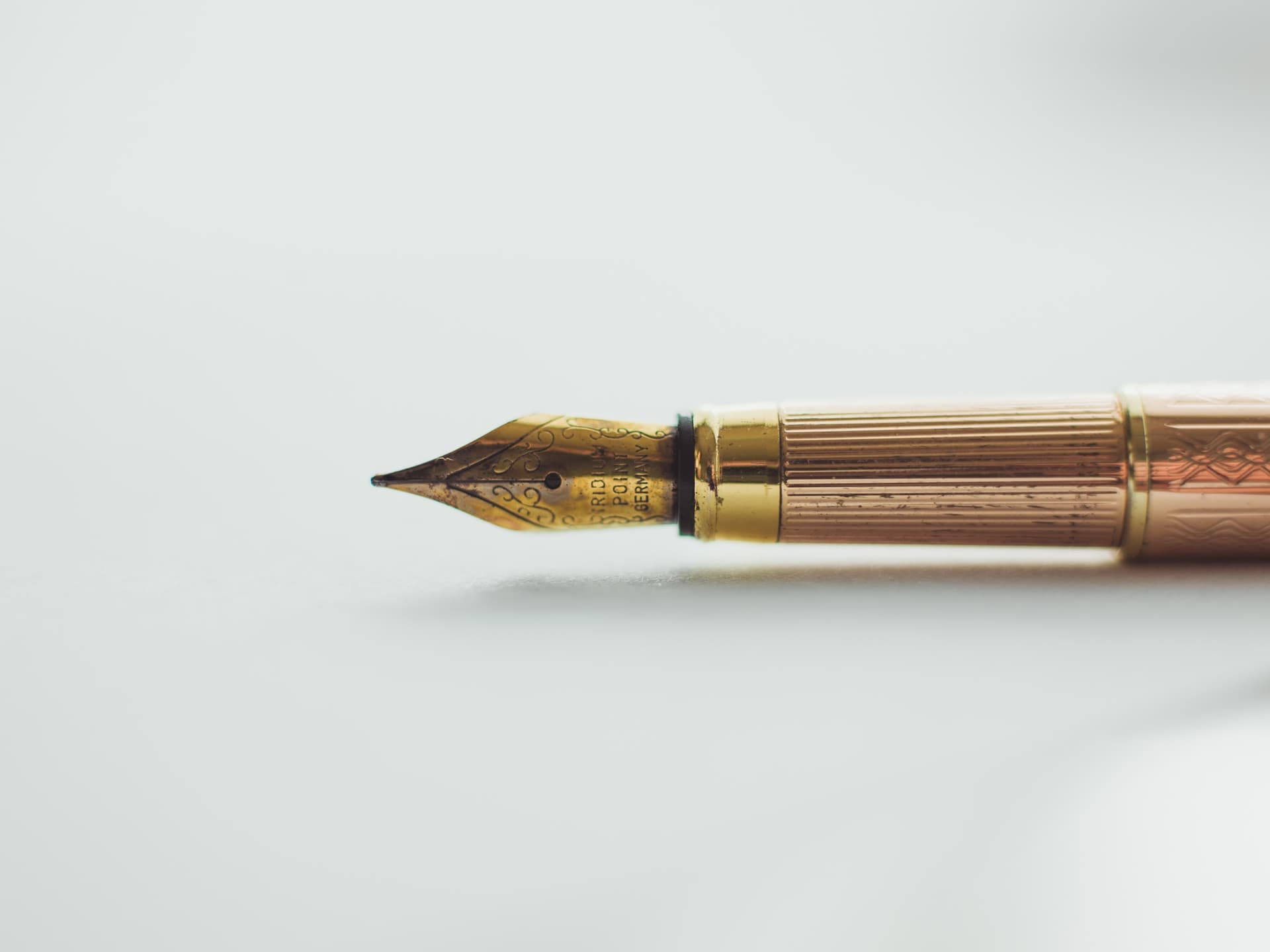 Classic fountain pen lying down on a white background