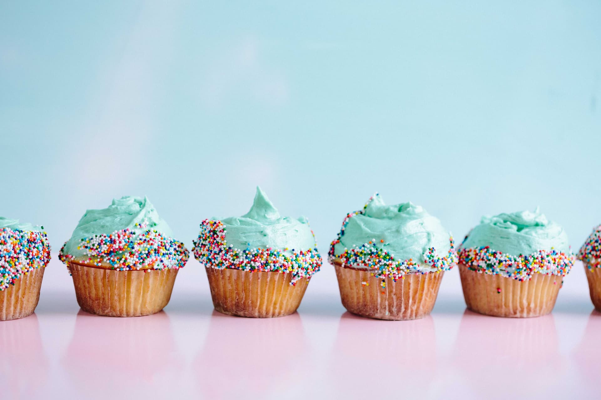 Teal icing cupcakes decorated with sprinkles