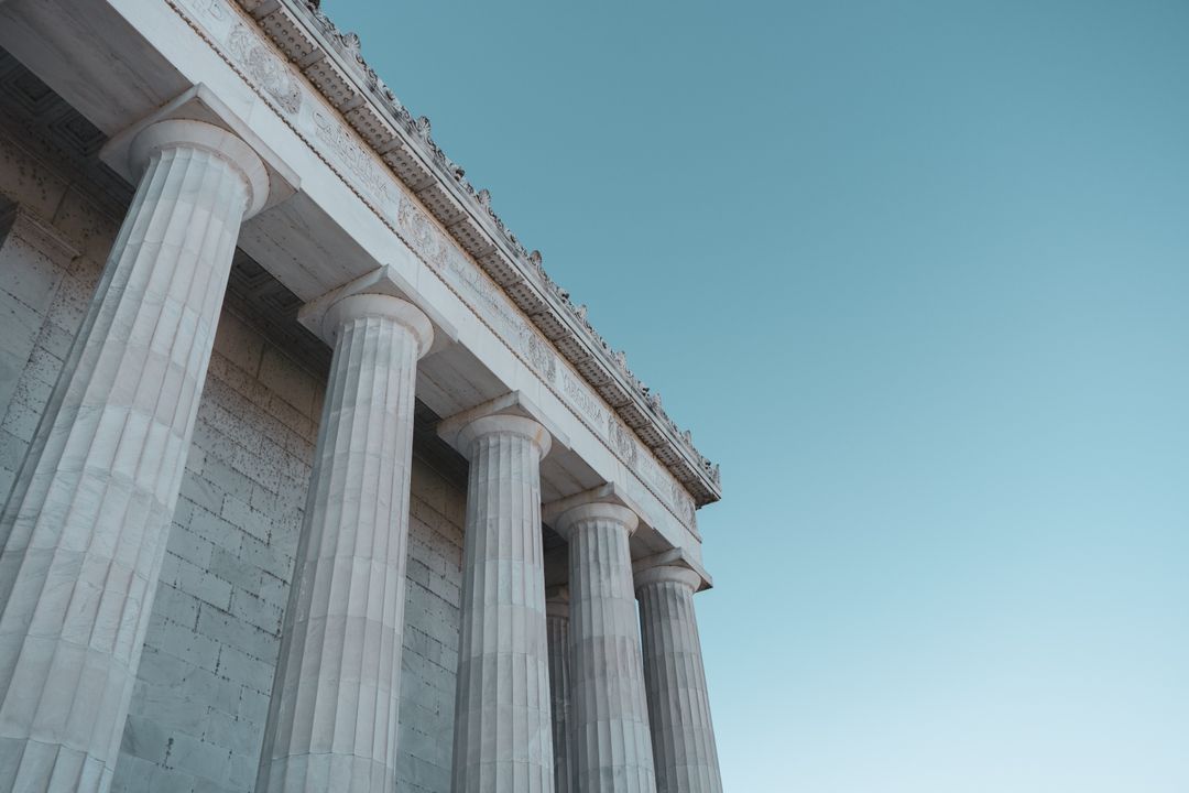 Four pillars of the concrete building under the blue sky