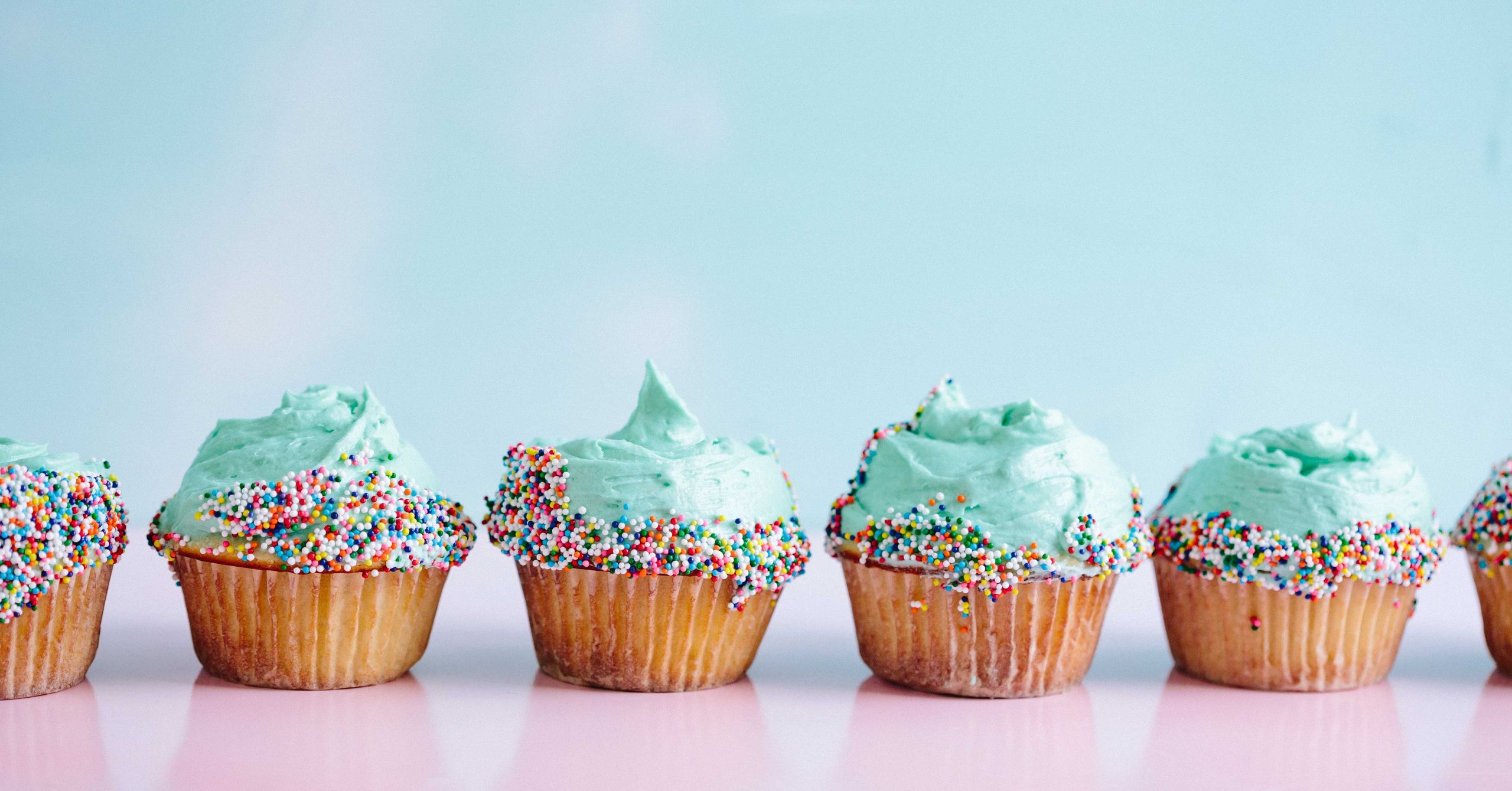 Teal icing cupcakes decorated with sprinkles