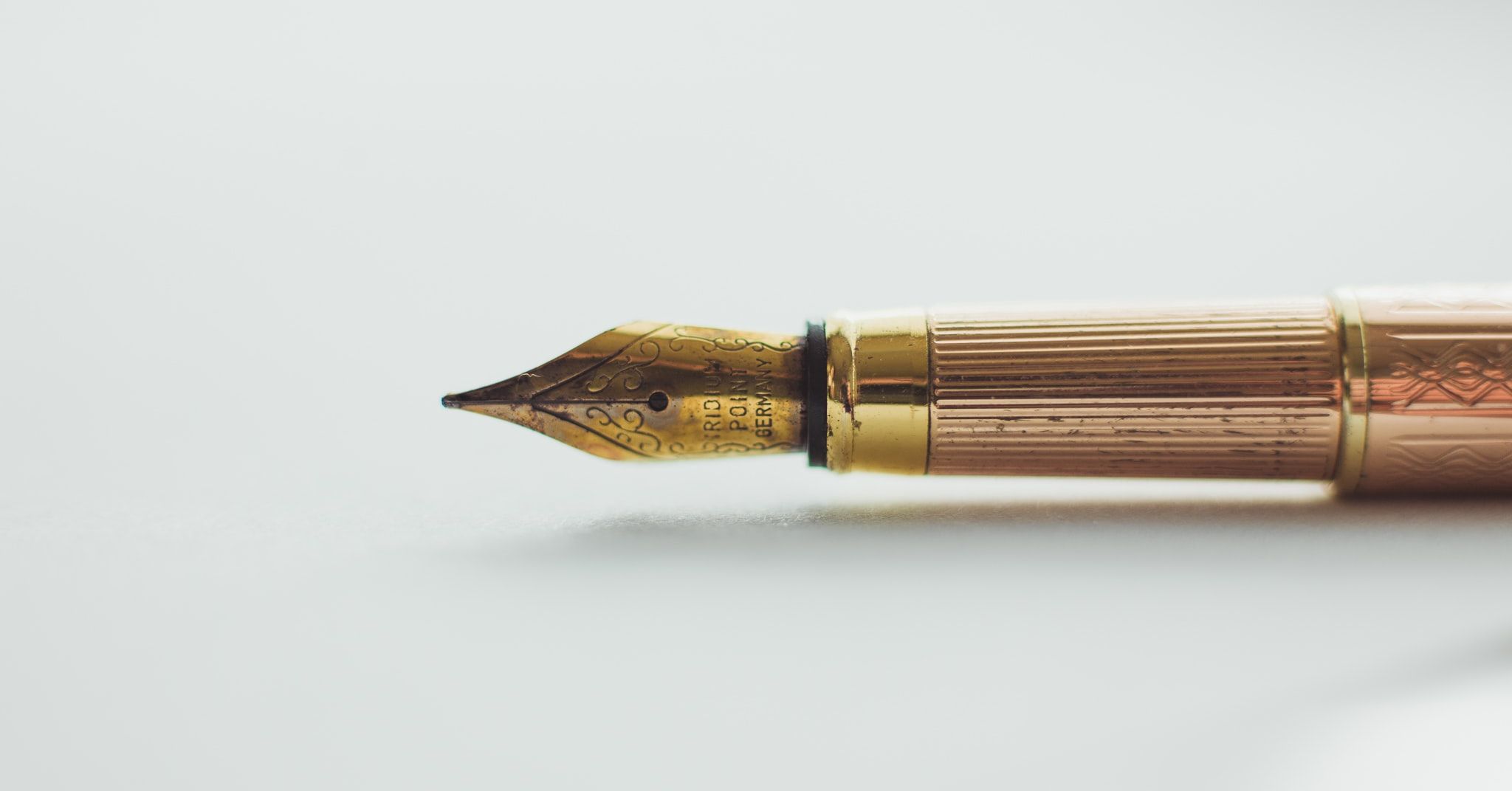 Classic fountain pen lying down on a white background